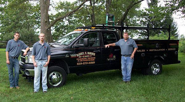 Darryl Barber plumbing & HVAC team standing by a work truck.