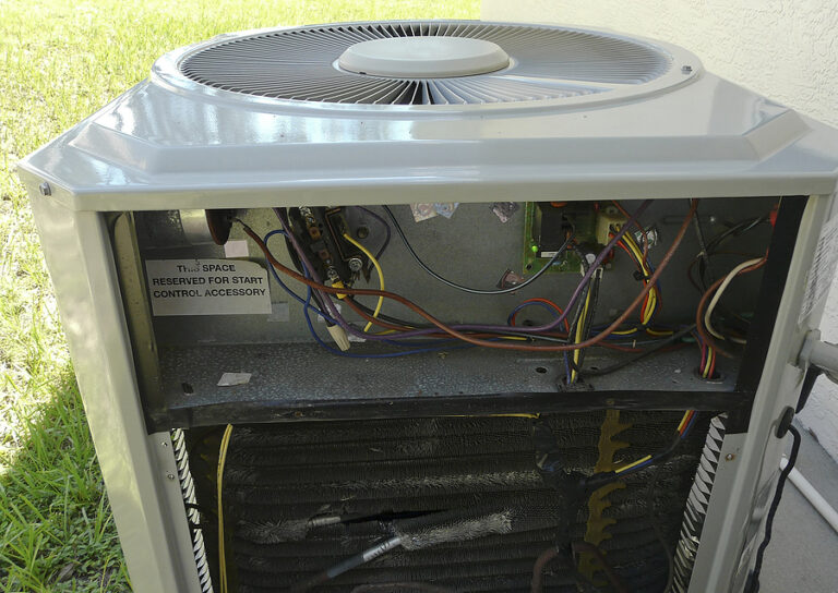 An AC unit with a panel open, showing interior components.