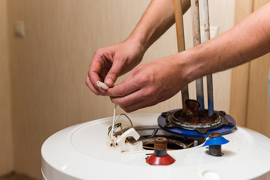 Plumber repairing water heater.